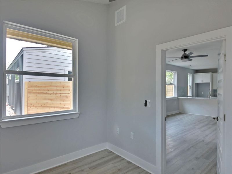 Empty room featuring light wood-type flooring and a ceiling fan