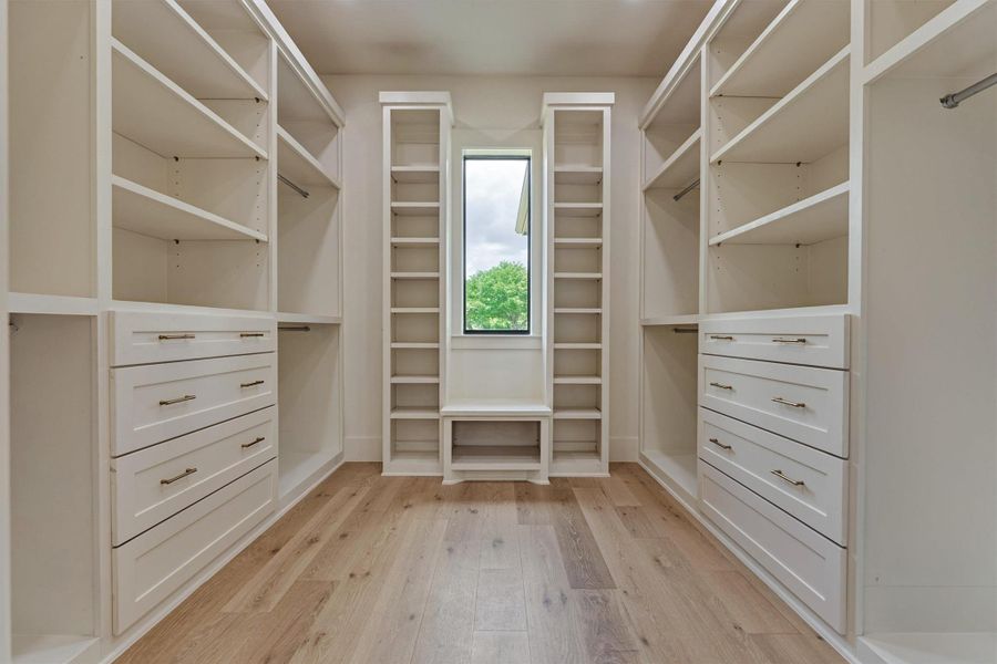 A California-style built-in closet system designed for serious organization — custom shelving, drawers, and hanging space on both sides, plus a sunlit window seat for the finishing touch. Storage has never looked this good. A California-style built-in closet system designed for serious organization — custom shelving, drawers, and hanging space on both sides, plus a sunlit window seat for the finishing touch. Storage has never looked this good.