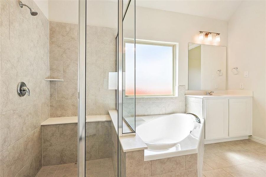 Bathroom with vanity, separate shower and tub, and tile patterned floors