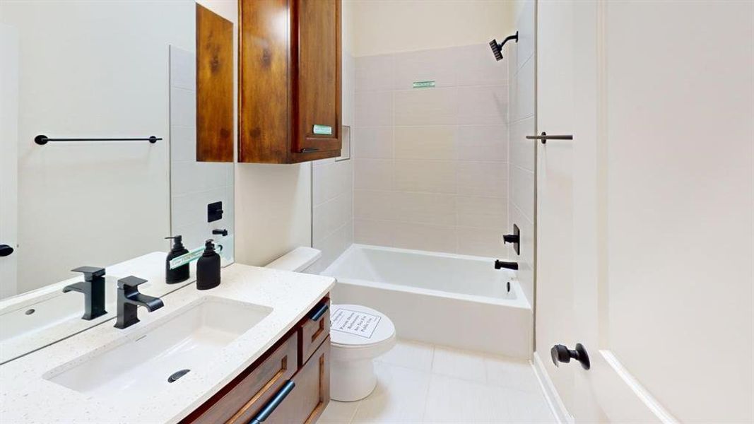Full bathroom featuring vanity, shower / bathtub combination, and tile patterned flooring