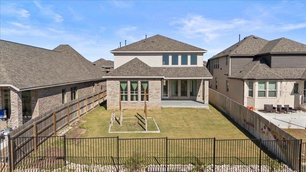 Rear view of house featuring roof with shingles, a patio area, a fenced backyard, and brick siding Rear view of house featuring roof with shingles, a patio area, a fenced backyard, and brick siding