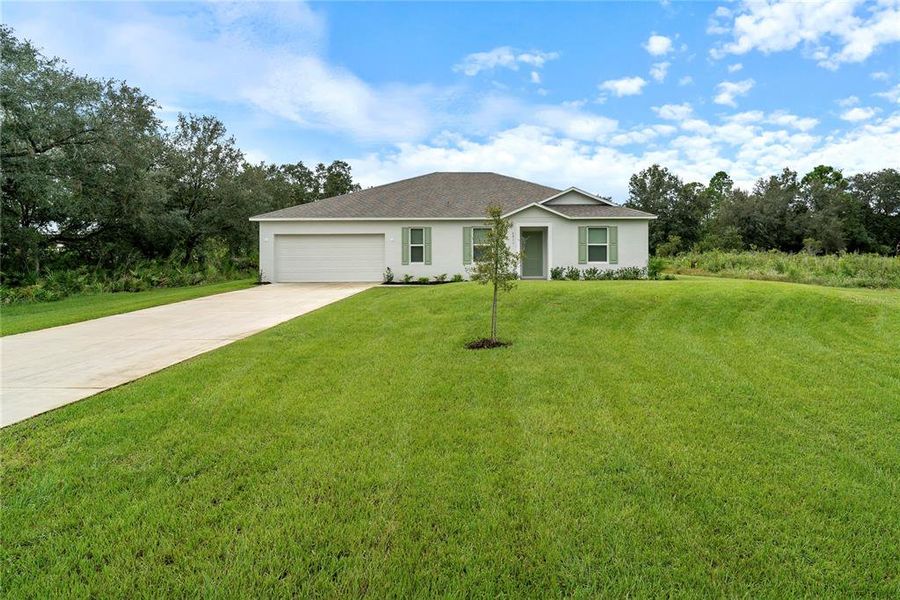 Front exterior of a new home in Indian Lake Estates, Indian Lake Estates, FL, highlighting curb appeal (Image 22).