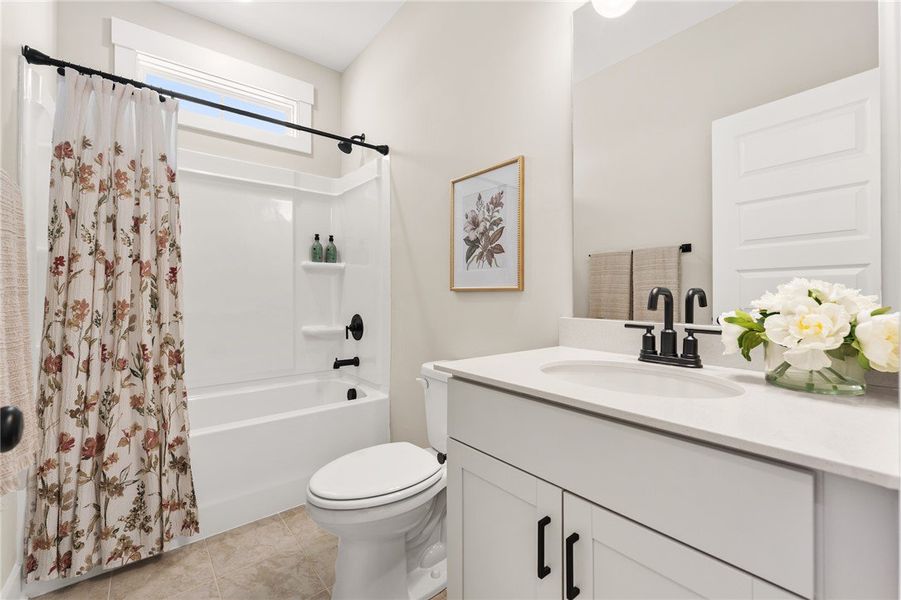 This bright bathroom features a vanity with a slee