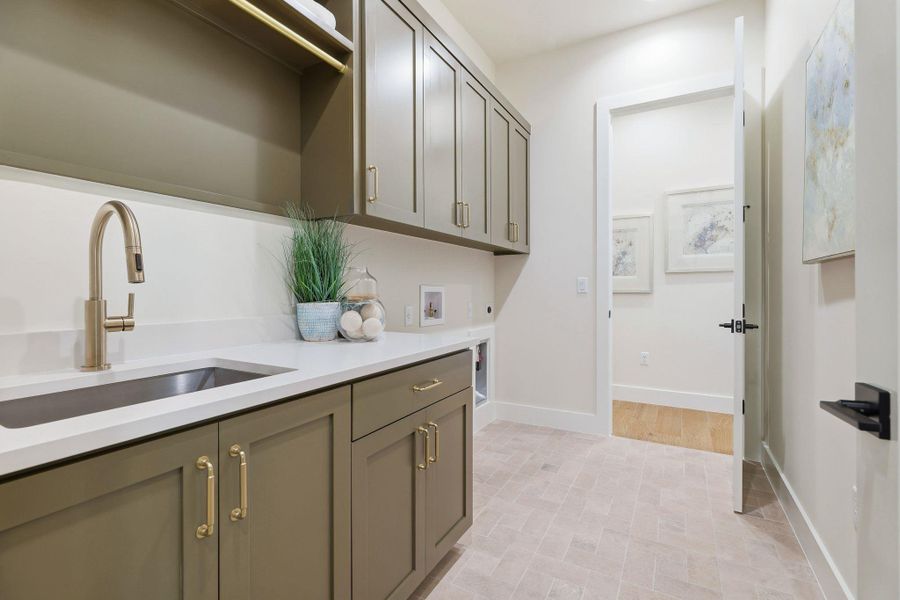 Washroom with cabinet space, washer hookup, and hookup for an electric dryer