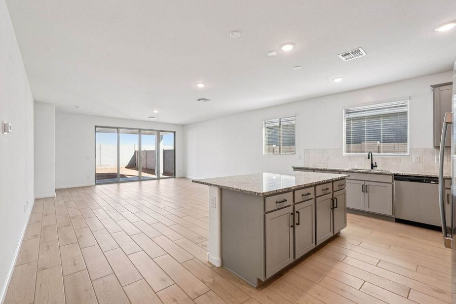 Kitchen, dining and great room. Finishes may vary by community.