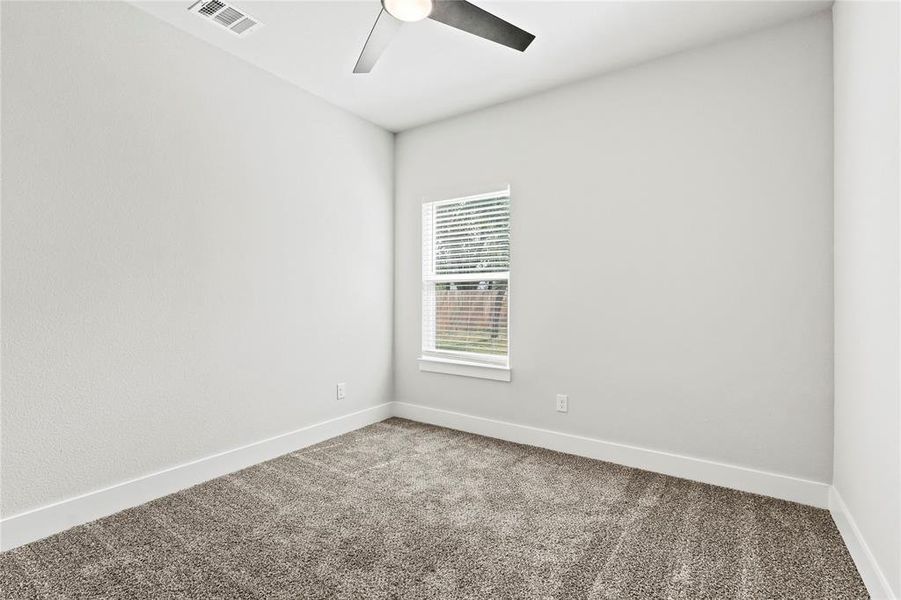 Carpeted spare room with baseboards and ceiling fan Carpeted spare room with baseboards and ceiling fan