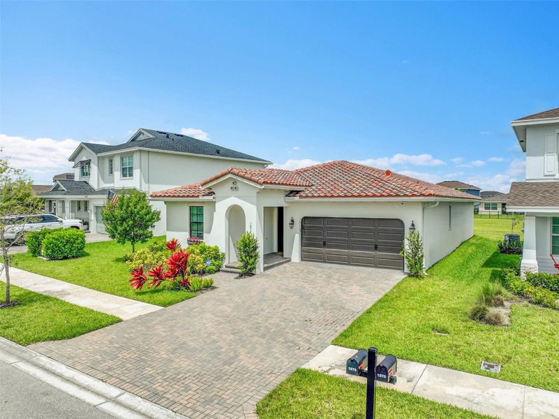 Front exterior of a new home in , Loxahatchee, FL, highlighting curb appeal (Image 2).