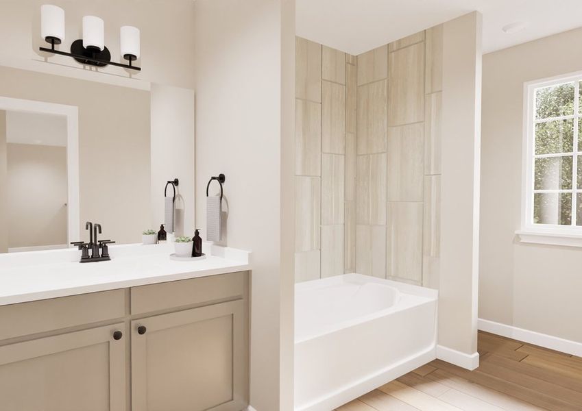 A modern bathroom features a beige vanity with a white countertop, accented by black fixtures. Nearby is a bathtub with tiled walls. The room is bright and minimalist. A modern bathroom features a beige vanity with a white countertop, accented by black fixtures. Nearby is a bathtub with tiled walls. The room is bright and minimalist.