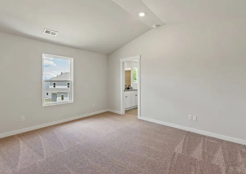 The master bedroom has lots of windows to let in natural light