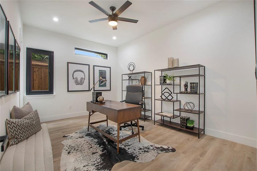 Home office with ceiling fan and light hardwood / wood-style floors