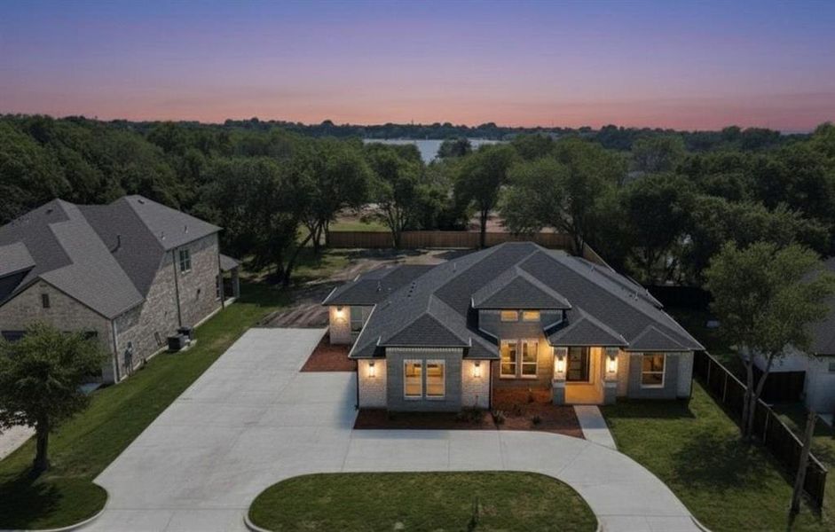 View of front facade featuring concrete driveway and brick siding