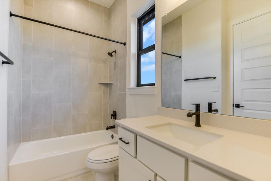 Bathroom featuring vanity and shower / bath combination