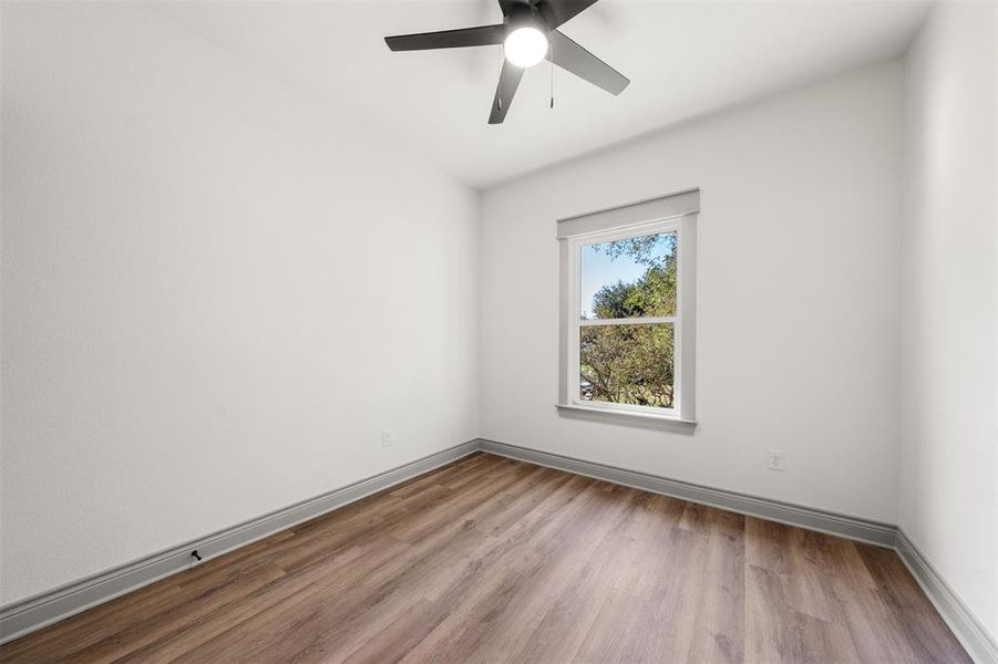 Unfurnished room with light wood finished floors and a ceiling fan