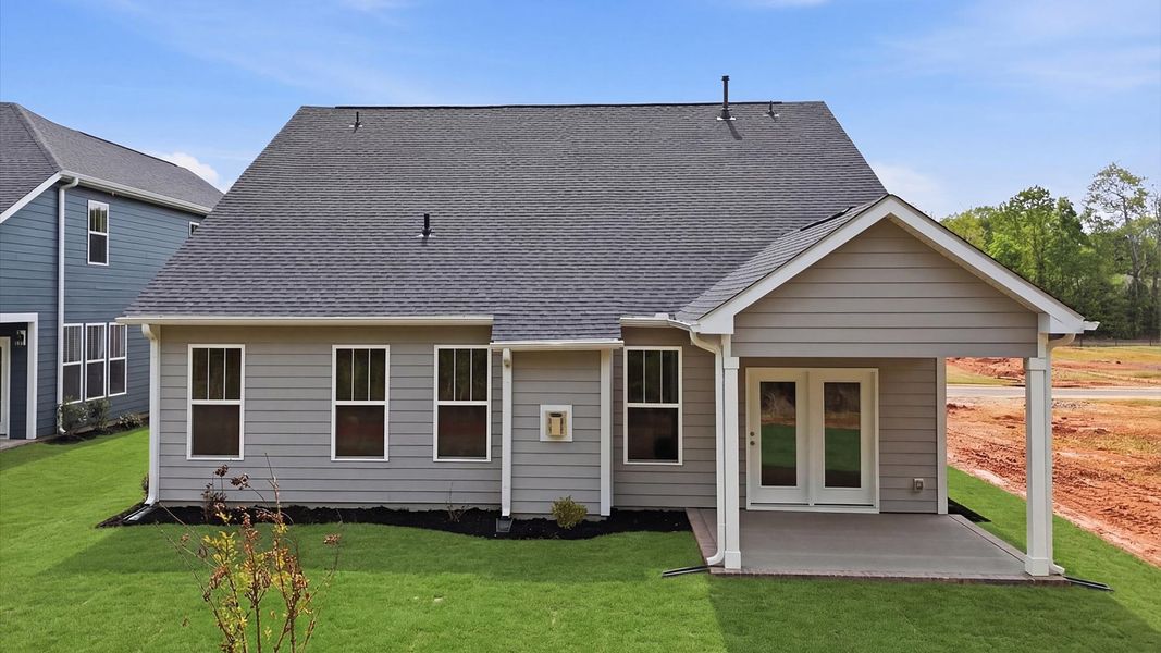 Refined rear exterior with a stylish covered porch for dining, relaxing, or entertaining at the Pelham Crossing community