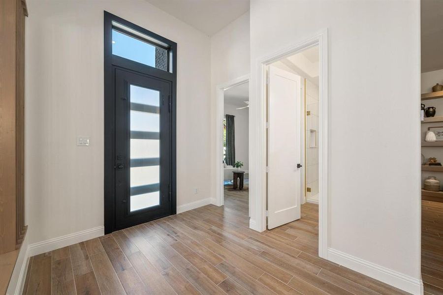 Entrance foyer featuring baseboards and light wood-style floors Entrance foyer featuring baseboards and light wood-style floors