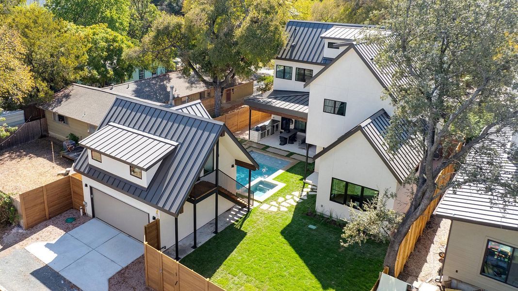 Access from a private rear alley allows for a garage-free front facade and an encapsulated back yard.