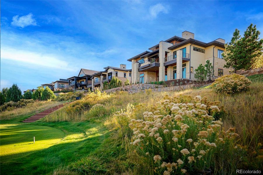 Just beyond the lawn, hand-laid stone steps invite you down to the fairways—where the landscape and golf course become an extension of home.