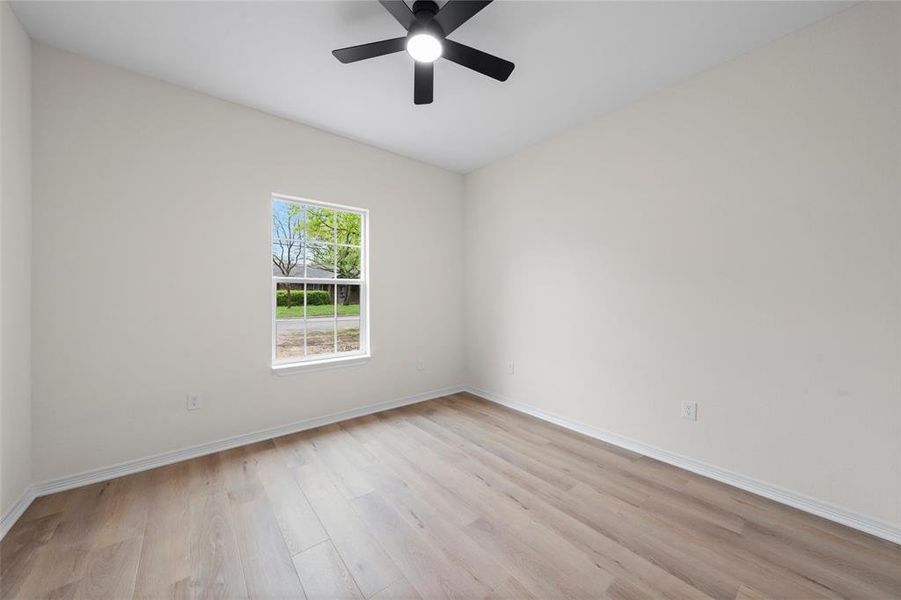Spare room with light wood-style flooring and ceiling fan