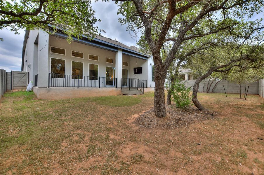 Rear view of property featuring a fenced backyard and stucco siding