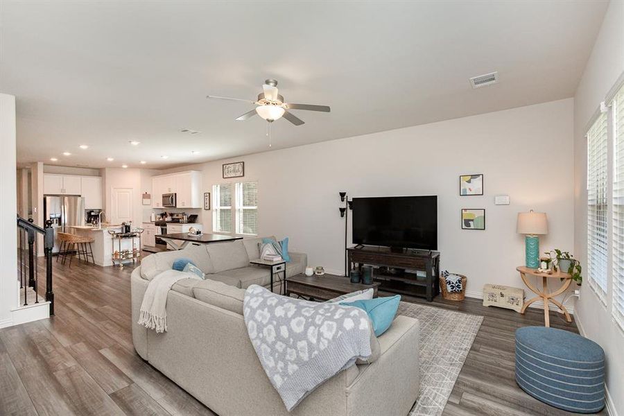 Living room featuring wood-type flooring and ceiling fan