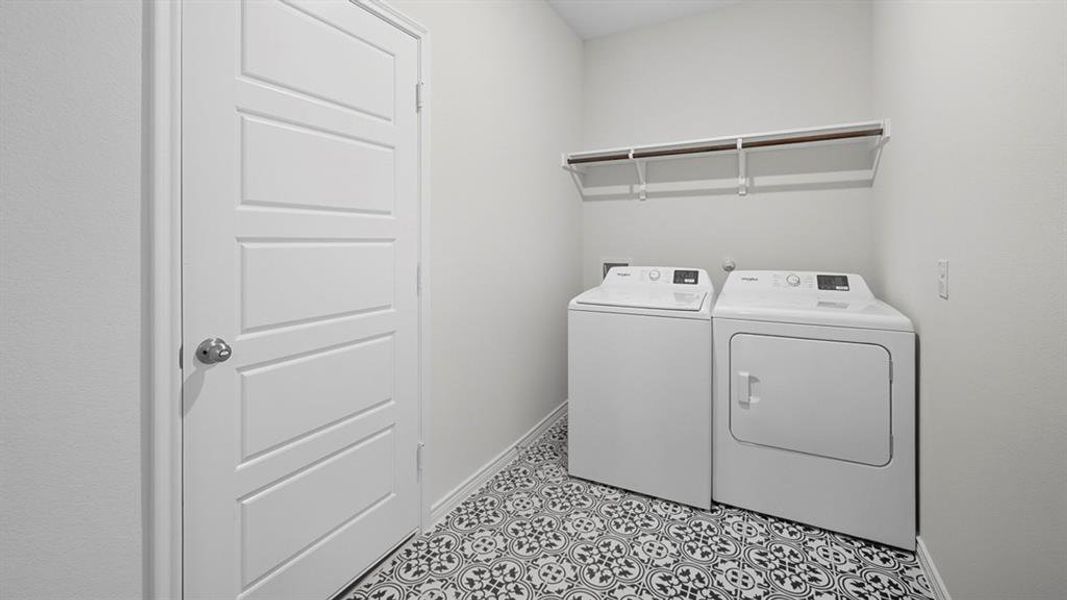 Laundry area featuring baseboards and washing machine and dryer