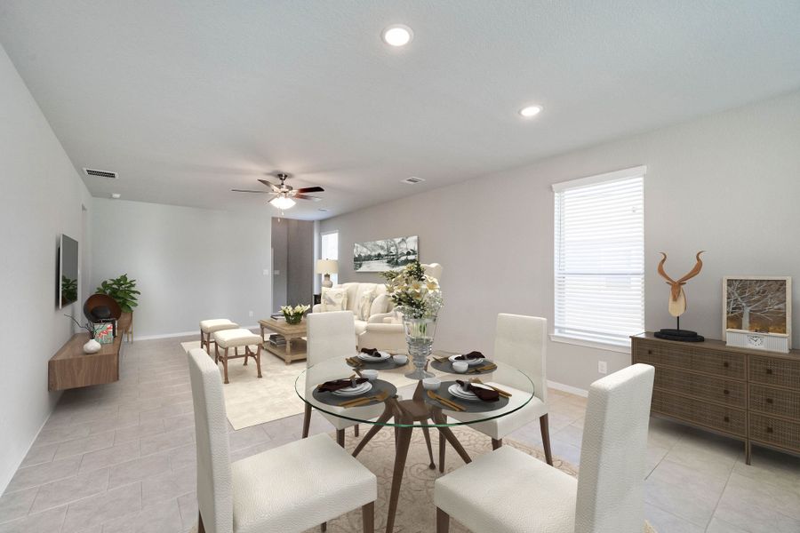 A living room with a table and chairs.