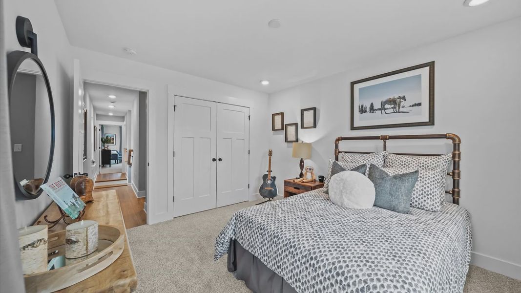 Highly functional bedroom with walk-in closet and tasteful carpet for a restful retreat