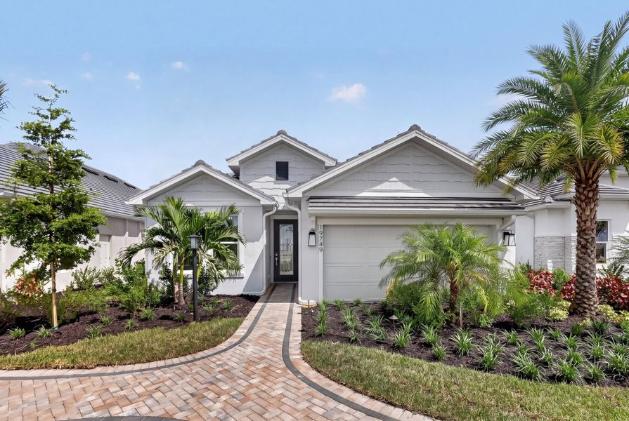 Front exterior of a new home in Esplanade at Kingston, Estero, FL, highlighting curb appeal (Image 21).