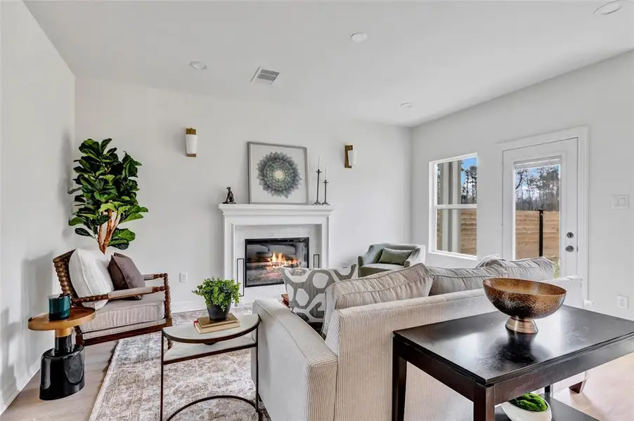 Warm living room featuring a stunning fireplace with a custom mantle.