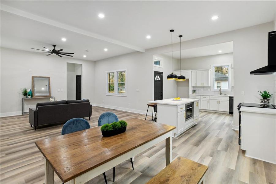 Dining area featuring ceiling fan, sink, and Luxury Vinyl Plank flooring