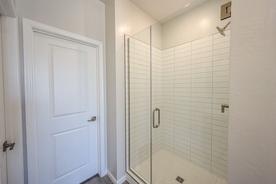 A shower with a glass door. A shower with a glass door.