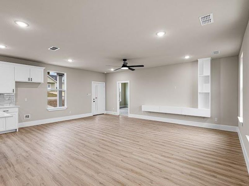 Unfurnished living room featuring light wood-type flooring, recessed lighting, and a ceiling fan Unfurnished living room featuring light wood-type flooring, recessed lighting, and a ceiling fan