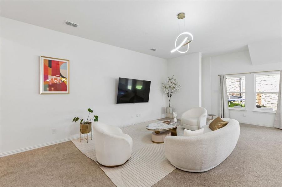 Spacious living area featuring neutral carpeting, white walls, and a contemporary ceiling light fixture