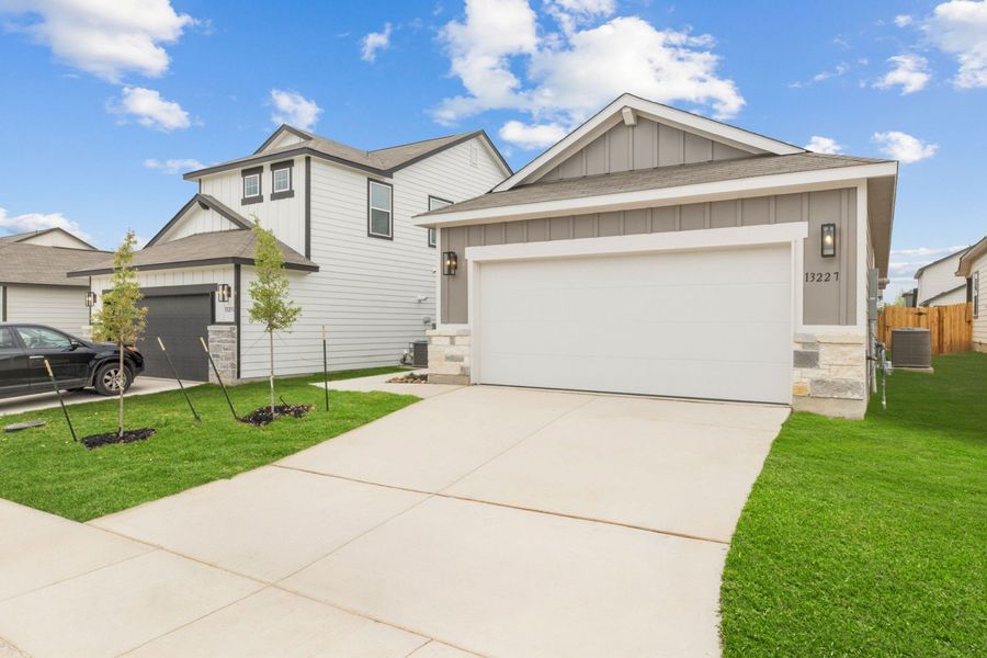 Front exterior of a new home in Veranda Designer, San Antonio, TX, highlighting curb appeal (Image 21).