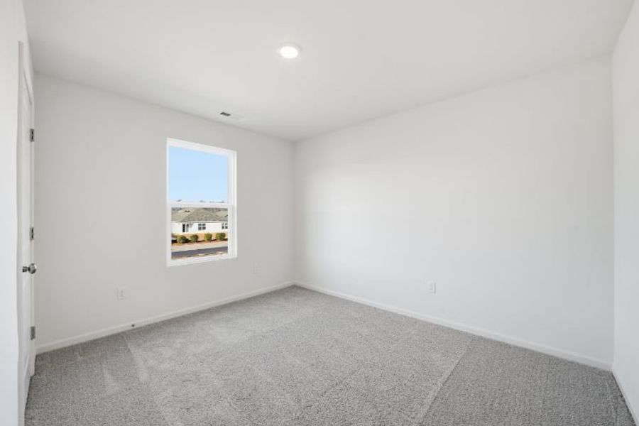 A room with a window and a carpet. A room with a window and a carpet.