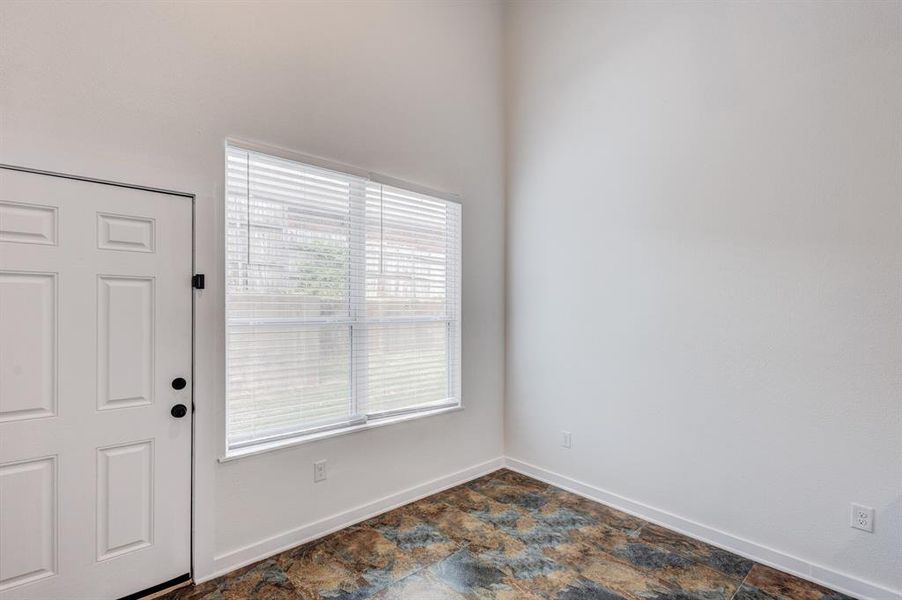 Entrance foyer featuring dark tile patterned flooring