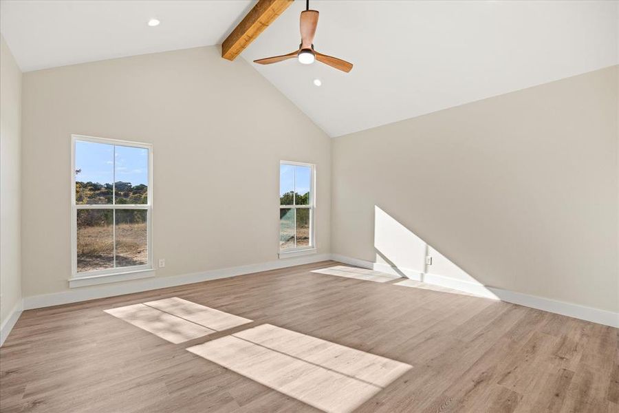 Bedroom with high vaulted ceiling, beamed ceiling, plenty of natural light, light wood-type flooring, and recessed lighting