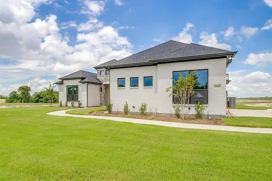 Front exterior of a new home in Peaks at Lone Elm, Waxahachie, TX, highlighting curb appeal (Image 19).