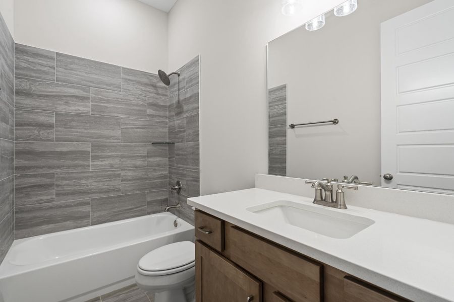 Bathroom featuring shower / bath combination and vanity