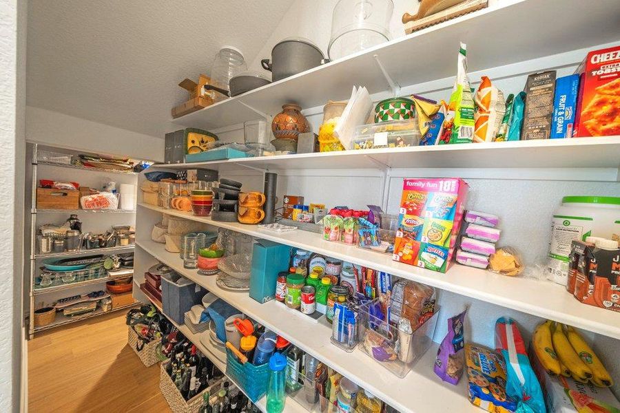 Ample built-in shelving provides abundant storage space within this walk-in kitchen pantry. Ample built-in shelving provides abundant storage space within this walk-in kitchen pantry.