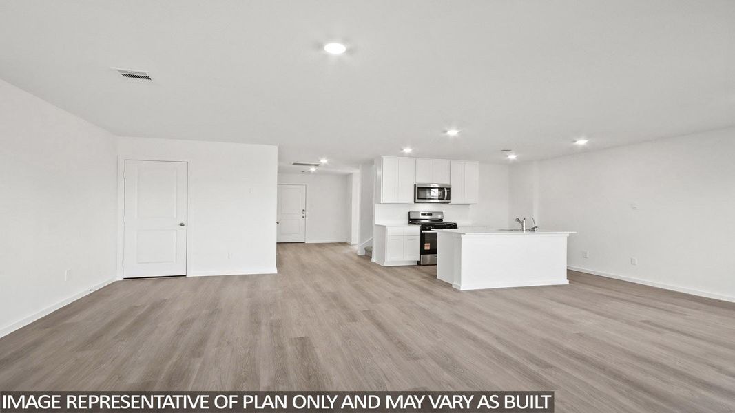 Open-concept living space featuring wood-finish flooring, recessed lighting, and white walls