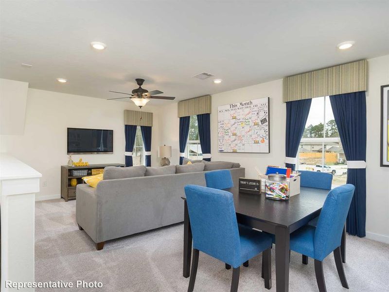 Dining area featuring light colored carpet, recessed lighting, and ceiling fan