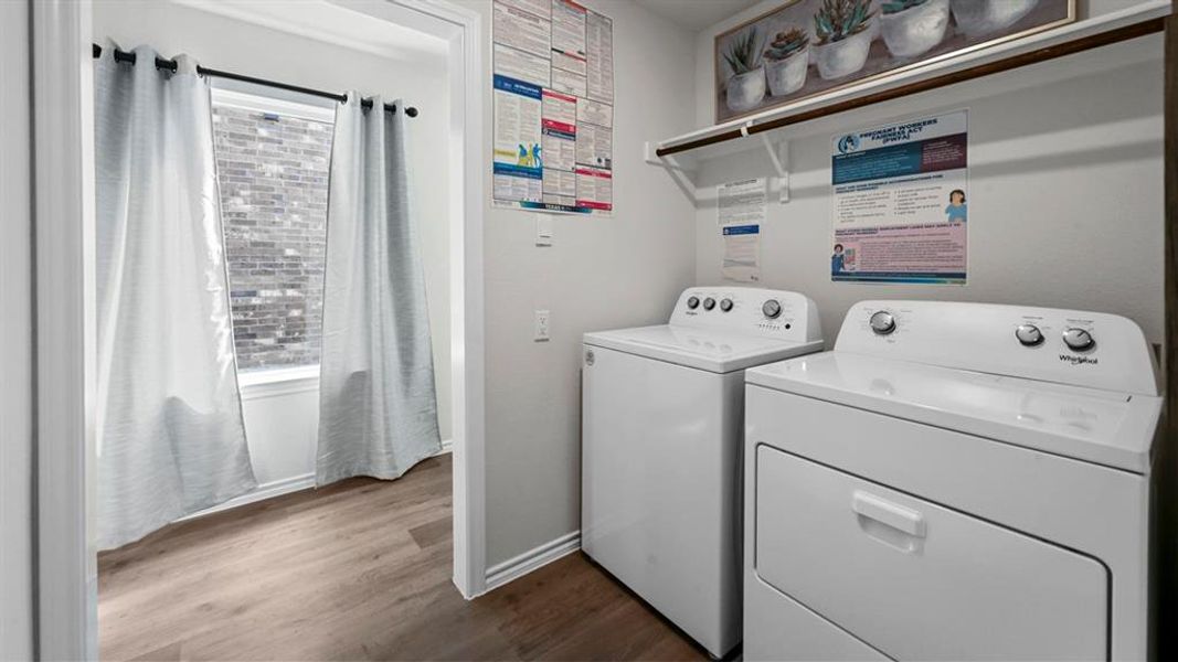 Washroom with washer and clothes dryer and dark wood-type flooring Washroom with washer and clothes dryer and dark wood-type flooring