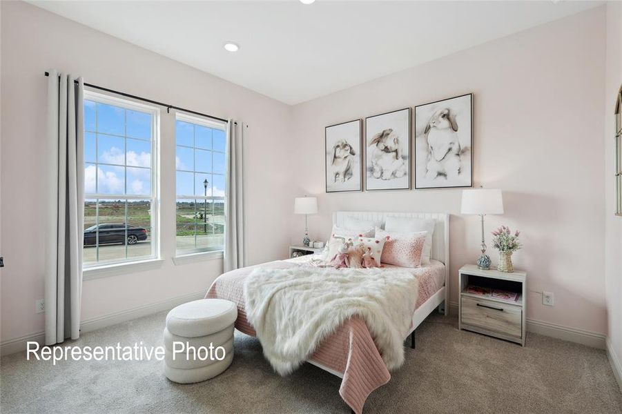 Bedroom featuring two large double-hung windows with grid patterns, recessed lighting, and soft carpet flooring