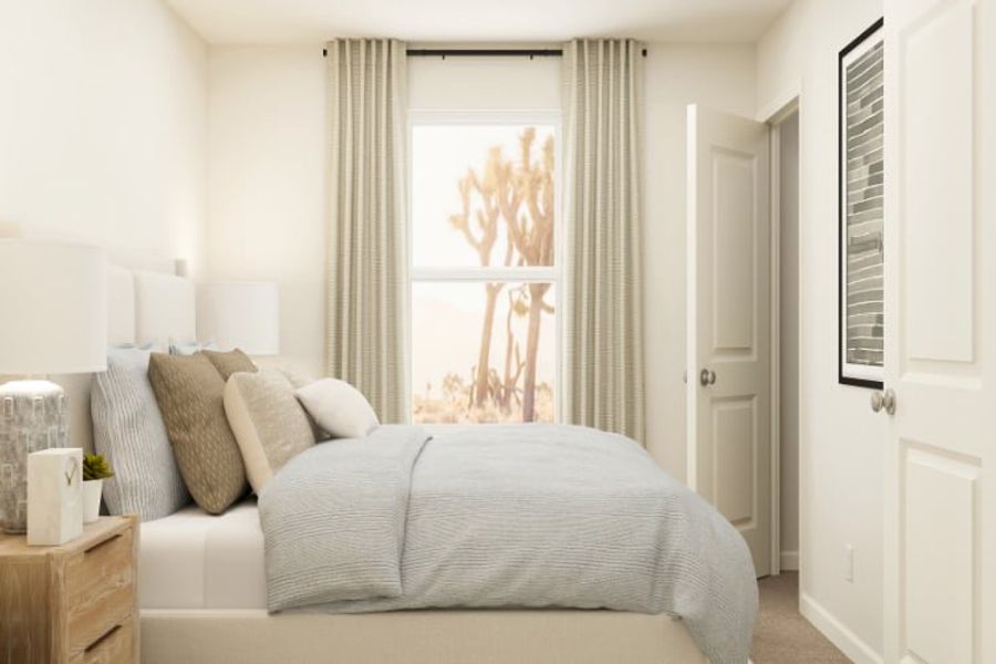 A bed with a white bed spread.