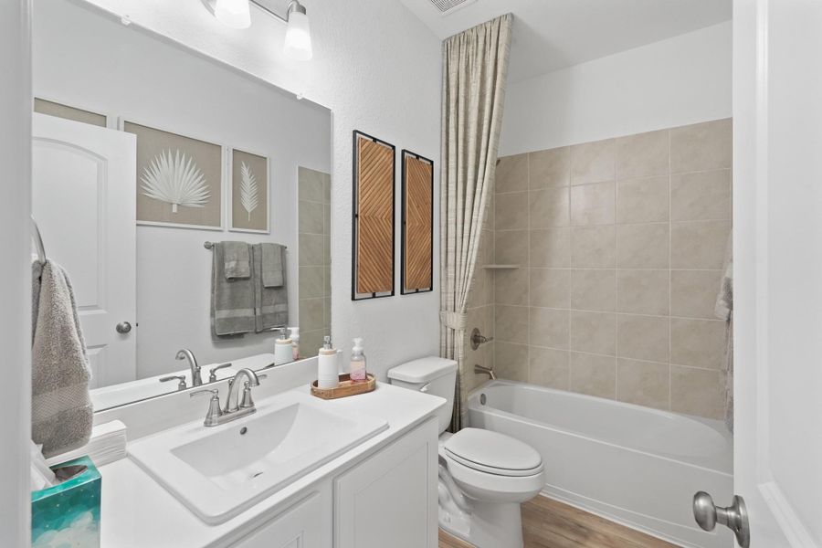 This secondary bath's fresh, timeless style ties in beautifully with the rest of the home’s design.