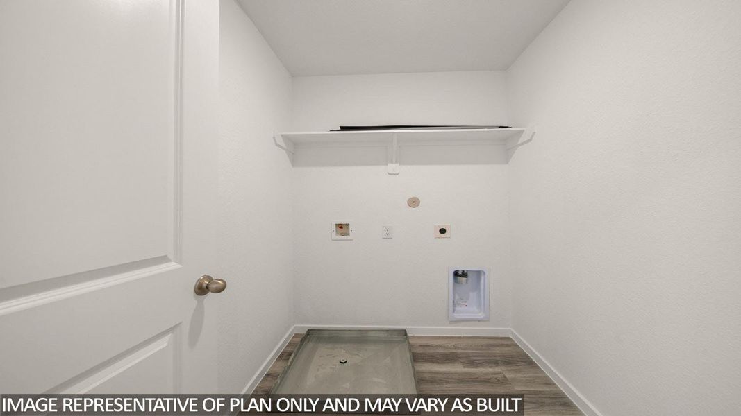 Dedicated utility space featuring a built-in shelf, wood-finish flooring, and a utility sink base