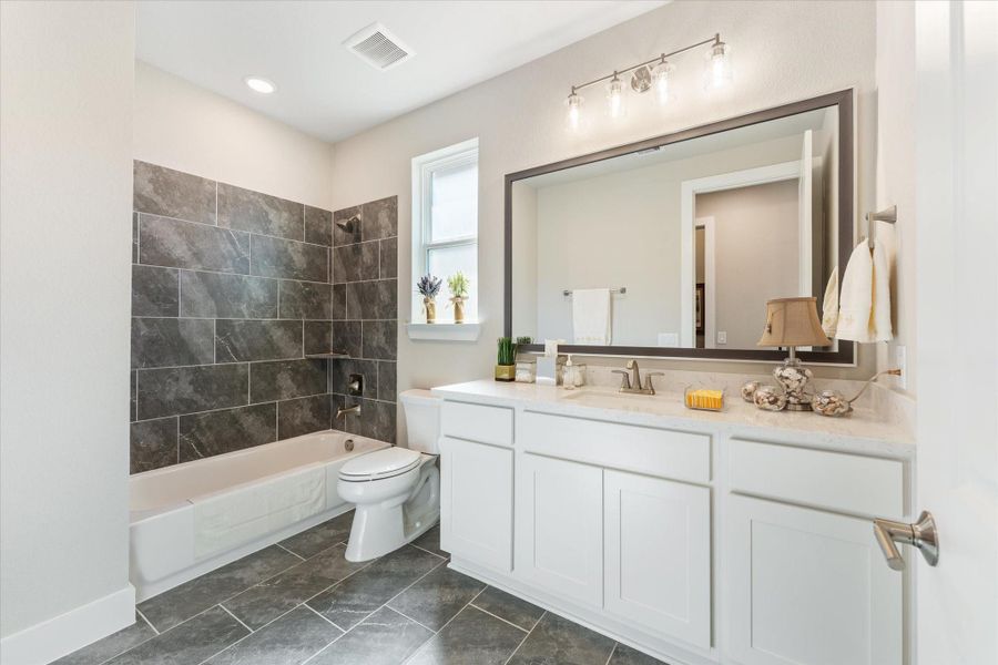 Second full bathroom with upgraded cabinetry and tile
