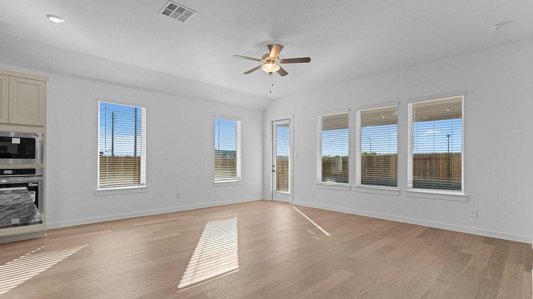 A well-organized living room that includes a kitchen and dining area, creating a warm and welcoming environment for gatherings.