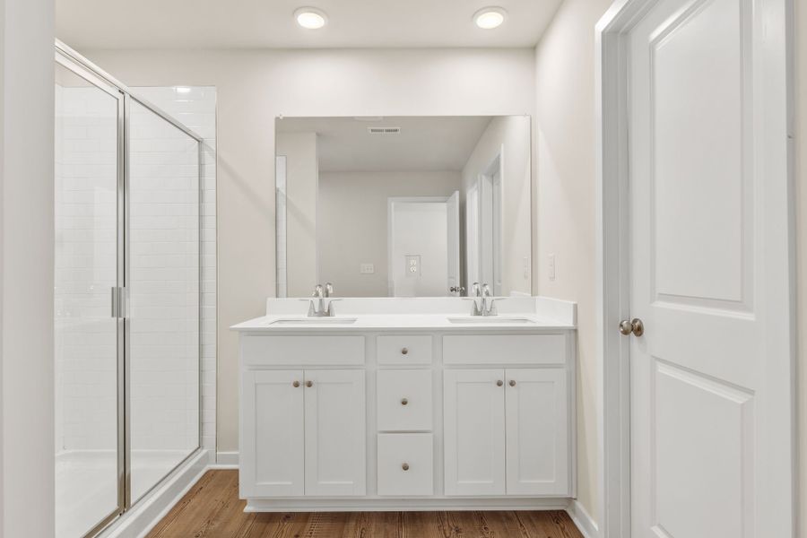 A bathroom with a sink and shower.